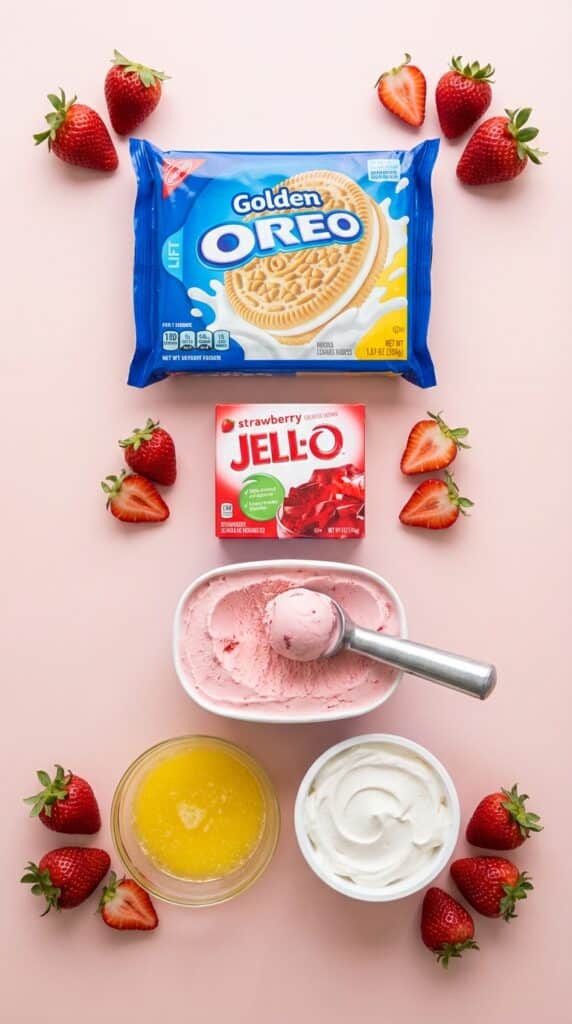 A flat lay showing Golden Oreos, strawberry jello powder, strawberry ice cream, and whipped topping.