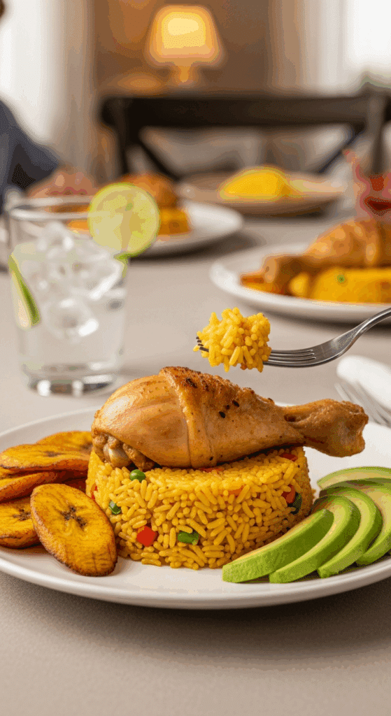 A plate of Arroz Con Pollo served with fried plantains and avocado, with a fork lifting a bite of chicken and rice.