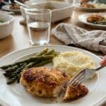 Places the protein in a complete meal context, offering serving suggestions (asparagus/potatoes) to the viewer.