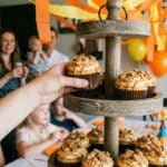 A tiered stand of peanut butter chocolate cupcakes at a party.