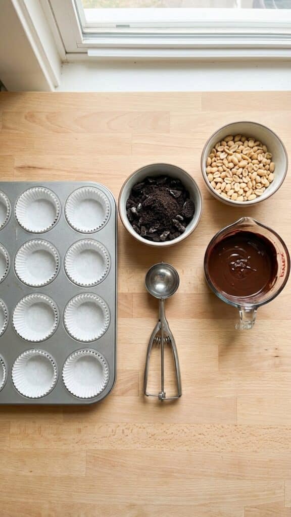 Flat lay of ingredients for round Buster Bars including a muffin tin and liners.