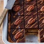 Close-up of a frozen ice cream round being dipped into chocolate shell.