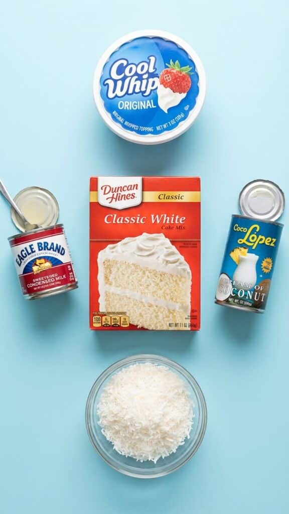 Ingredients for coconut cake including cake mix, condensed milk, cream of coconut, and cool whip.