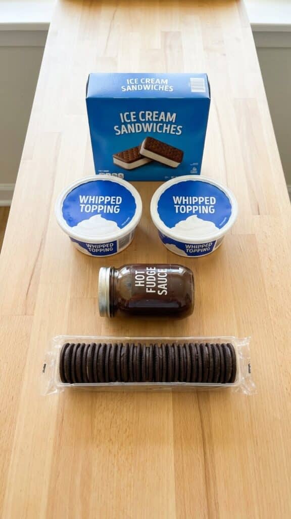 Flat lay of ingredients for ice cream cake including a box of sandwiches.