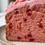 A detailed macro shot. It creates appetite appeal by showing that the cherries are distributed throughout the cake, not just sunk to the bottom.