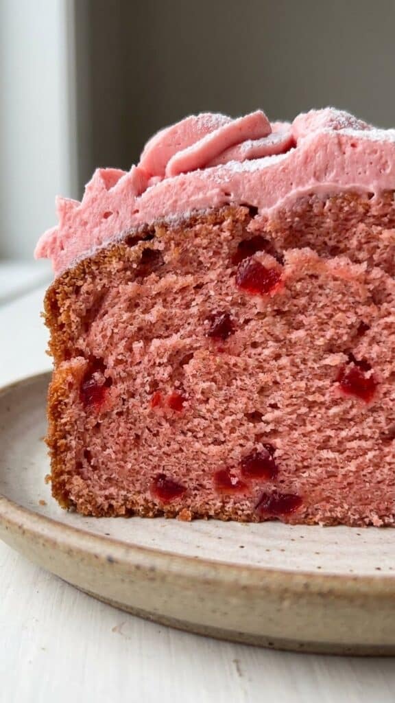 A detailed macro shot. It creates appetite appeal by showing that the cherries are distributed throughout the cake, not just sunk to the bottom.