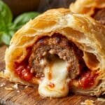 Close-up cross-section of a meatball roll-up showing the filling.