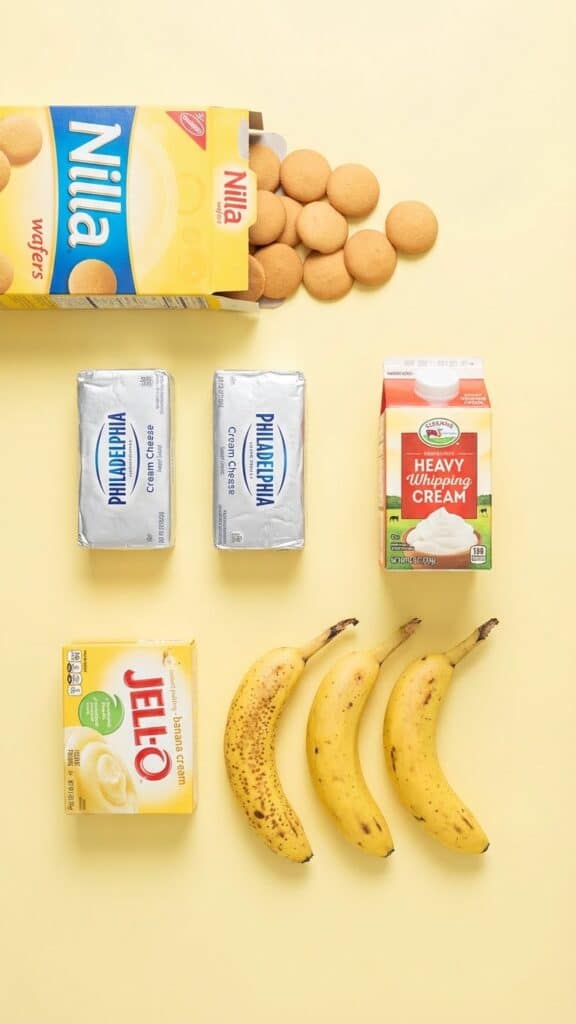 Flat lay of ingredients for banana cheesecake including Nilla Wafers, bananas, and pudding mix.