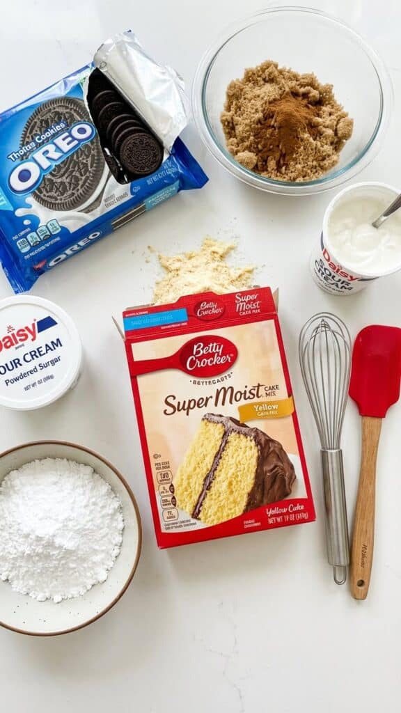 Ingredients for Oreo honeybun cake including yellow cake mix, oreos, brown sugar, and cinnamon.