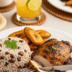 A plate of baked jerk chicken served with rice and peas and fried plantains, with a fork cutting into the juicy chicken thigh.