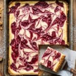 Overhead shot of a pan of swirled rhubarb cheesecake bars.