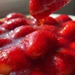 Close-up of glazed strawberries on top of a cream cheese pie