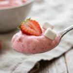 Close-up of a spoonful of creamy strawberry fluff.