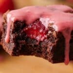 Close-up of a bitten strawberry white chocolate brownie showing the dense texture.