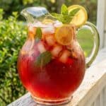 Close-up of a glass of strawberry sweet tea glowing in the sunlight.