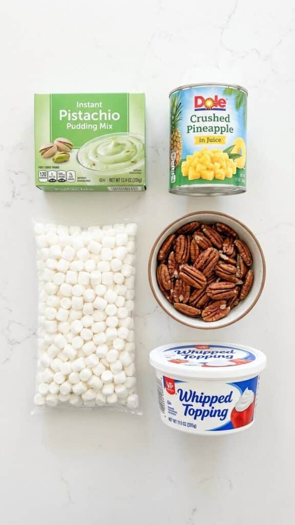 Flat lay of ingredients for Watergate salad including pistachio pudding, pineapple, and marshmallows.