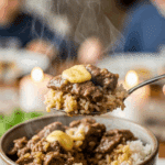 Person holding a bowl of hot garlic butter beef and rice.