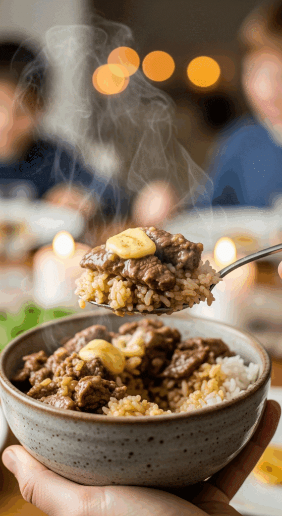 Person holding a bowl of hot garlic butter beef and rice.