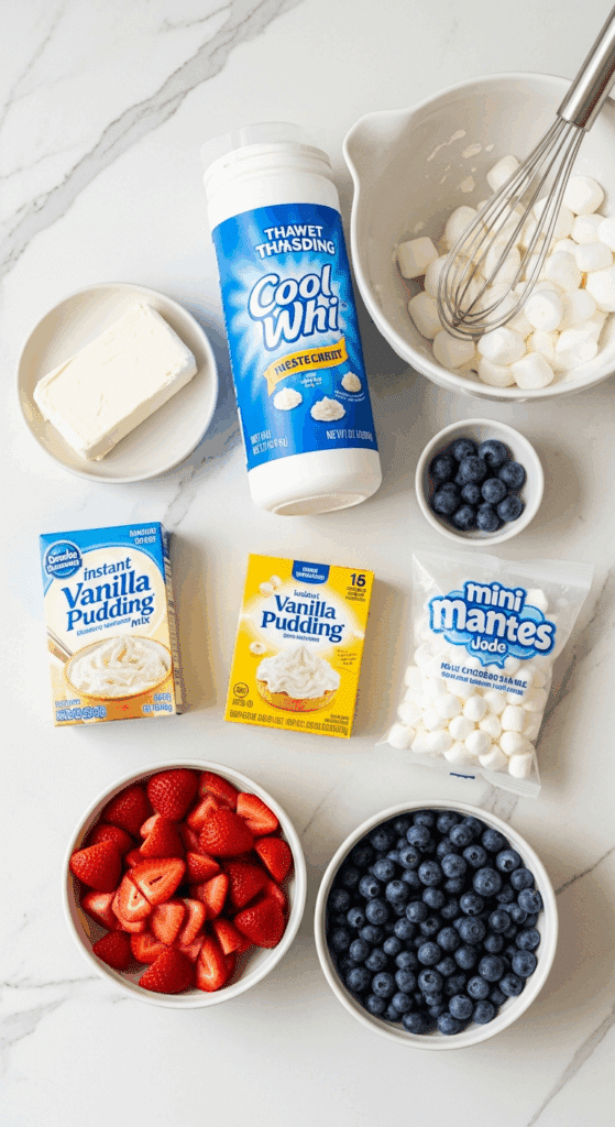 Ingredients for cheesecake salad: cream cheese, whipped topping, pudding mix, strawberries, blueberries, and marshmallows.